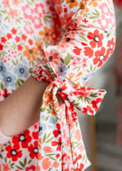 Model wearing the Nuggles® Hazel Dress in Confetti Garden Bloom floral print modest boutique dress