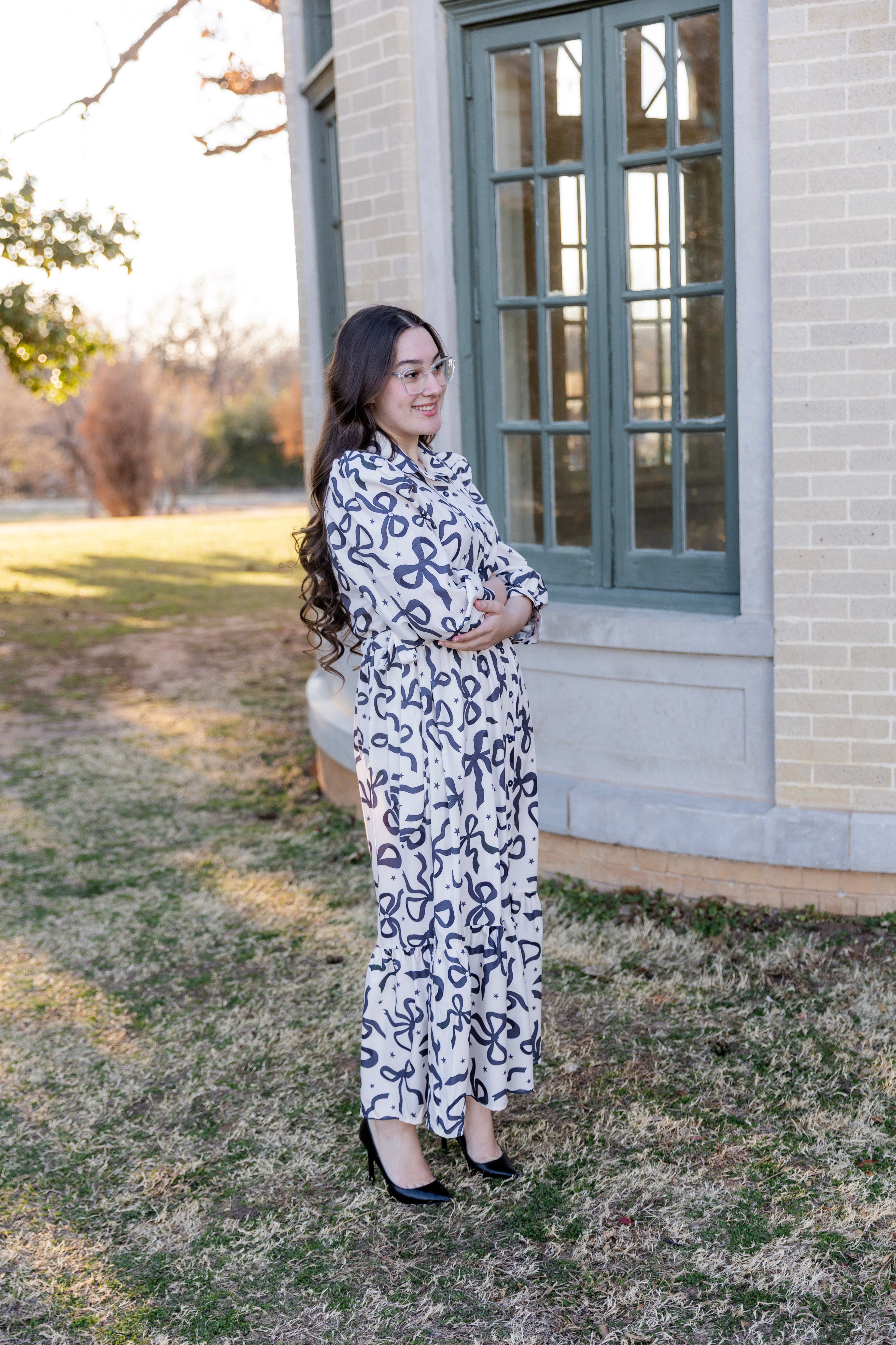 Model wearing the Nuggles® Leila Dress in Bow & Tell