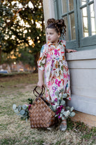 Model wearing the Nuggles® Girls' Rachel Dress in Bow Garden
