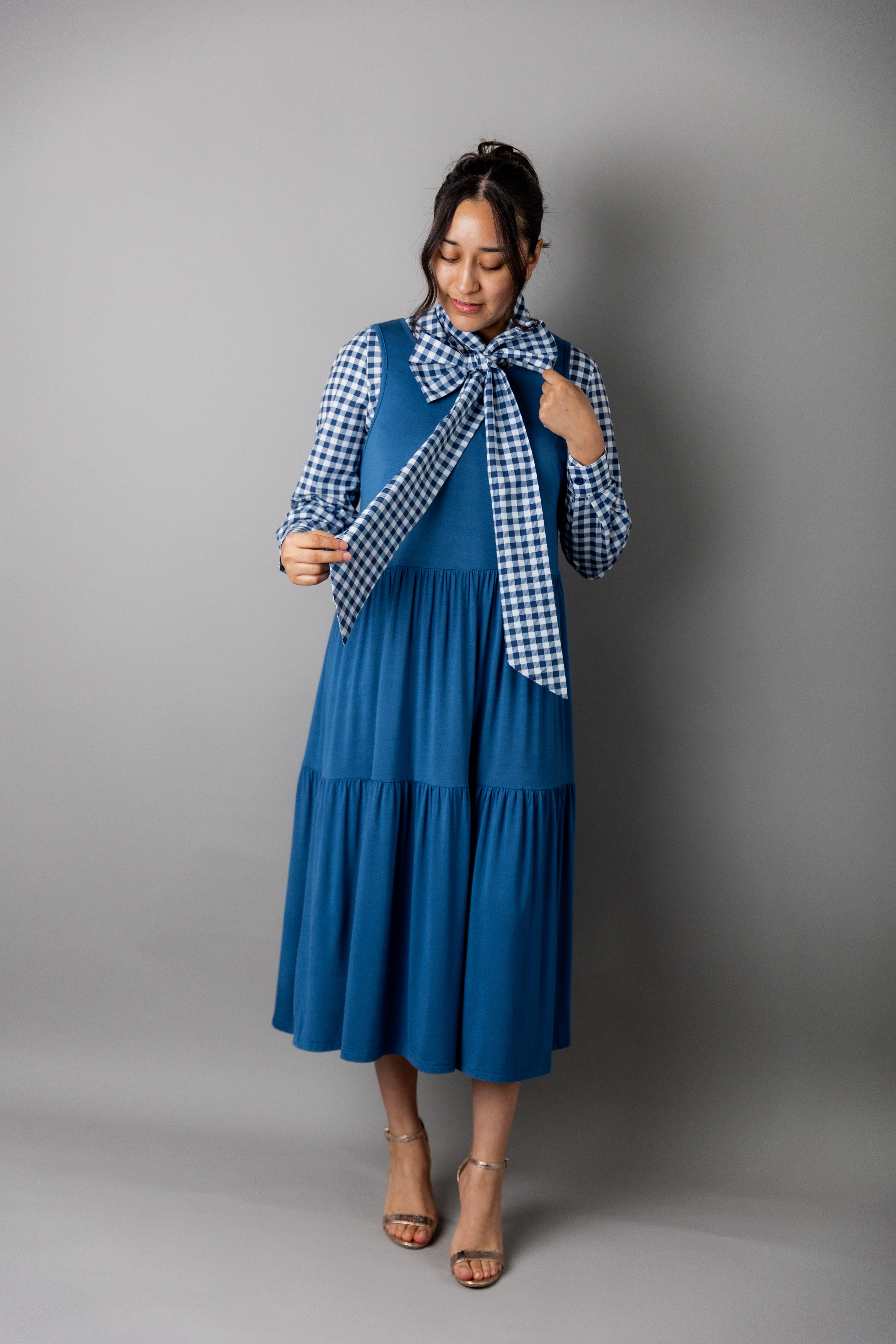 Model wearing Nuggles® Felicity top with large bow tie neckline, modest women's blouse.