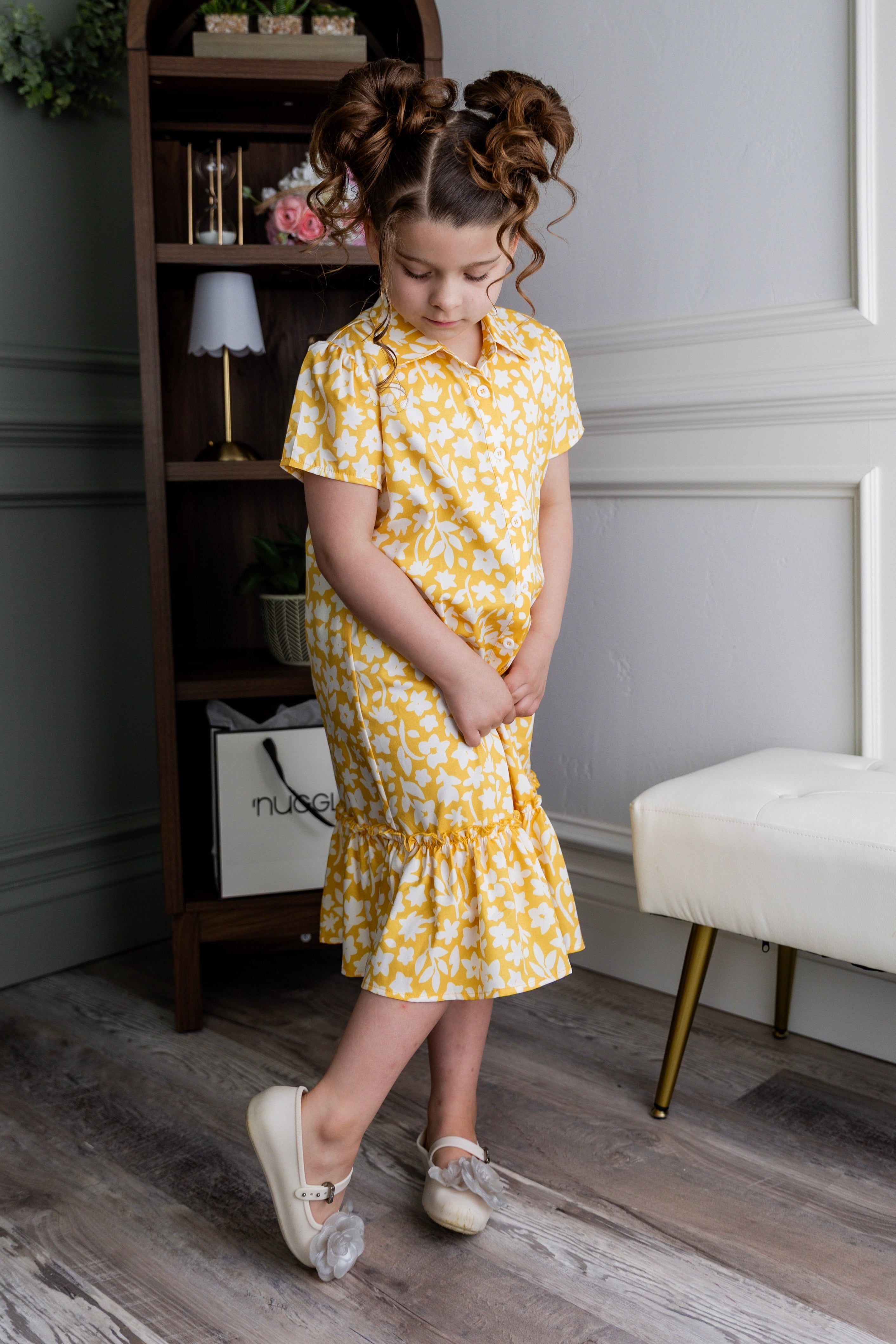 Model wearing Nuggles® Girls' Ellie Dress Dress in Sunshine Sprigs