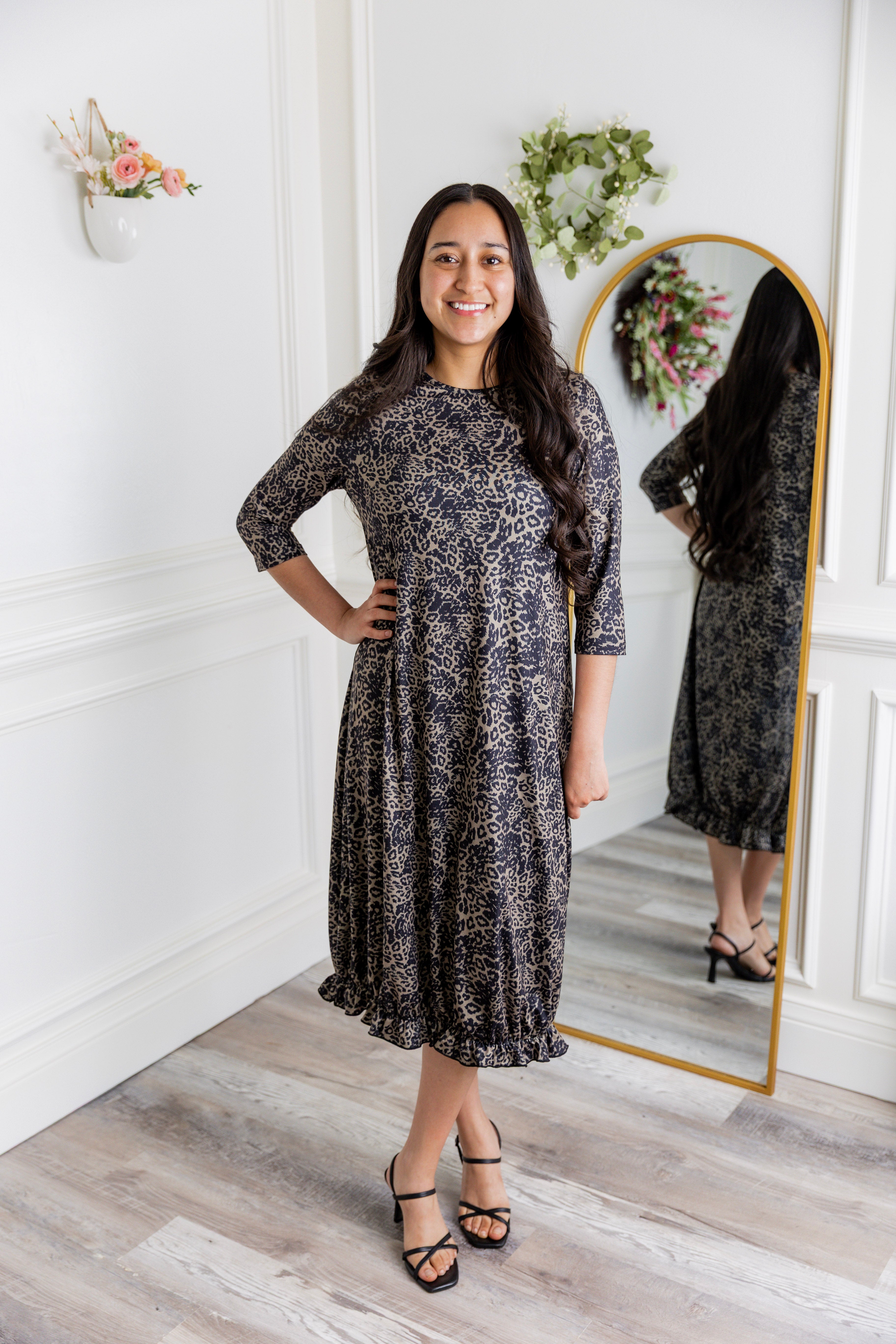 Model wearing our Nuggles® modest Bristol midi dress with 3/4 sleeves and elastic ruffle hem in various prints.