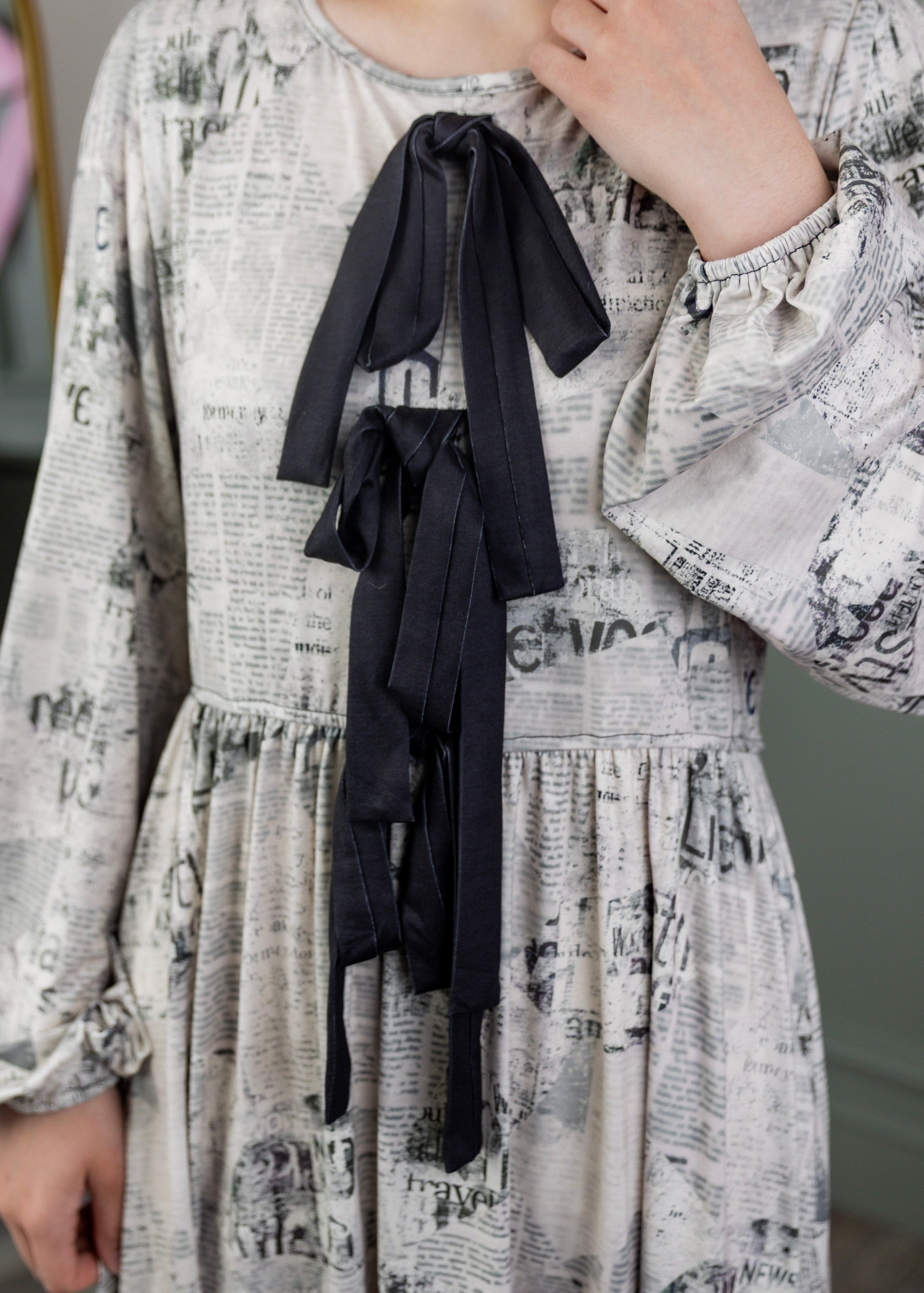 Model wearing the Nuggles® Addison Dress in Whispering Headlines