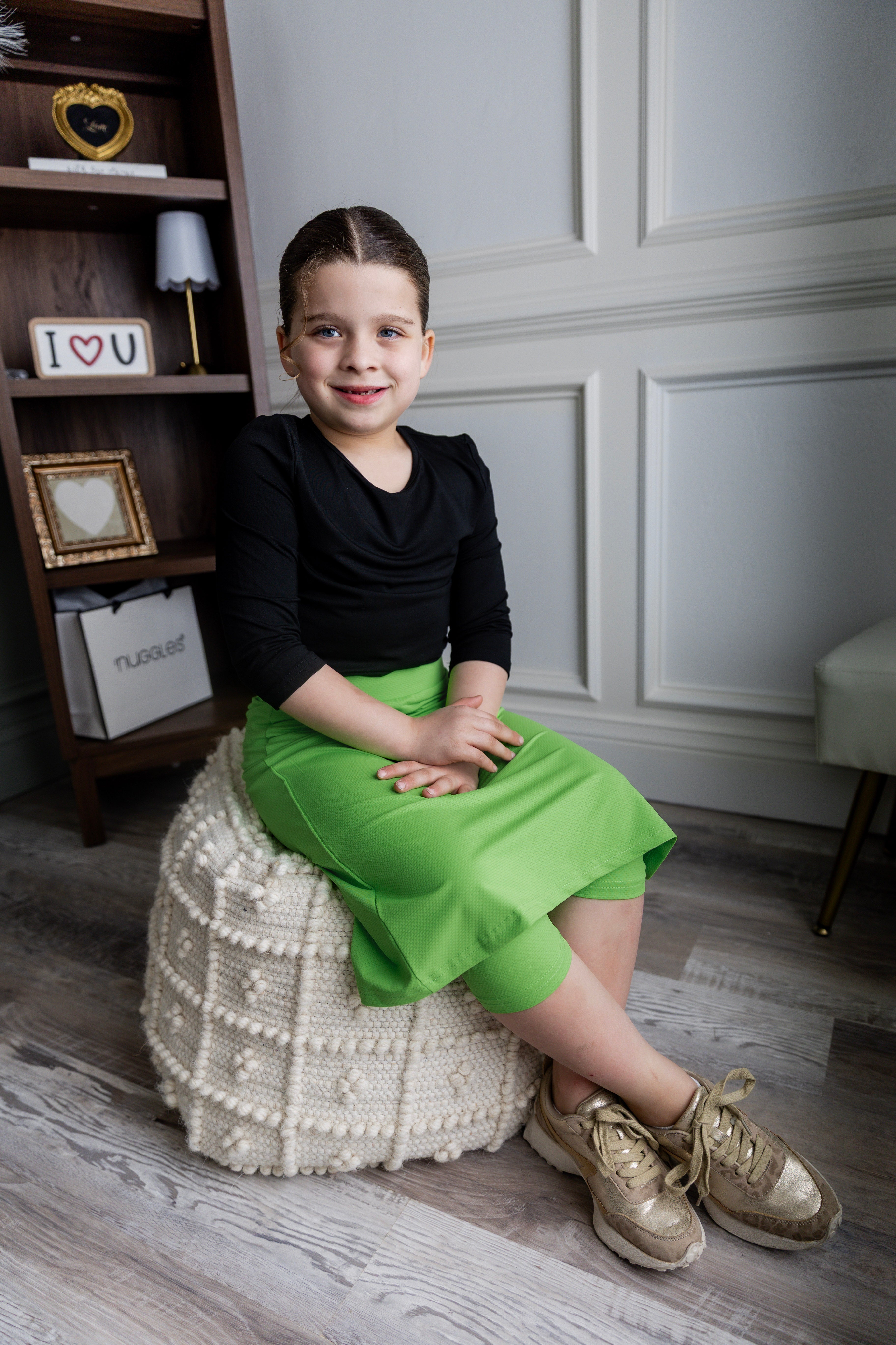 Model wearing Nuggles® Girls' All-Sport Skirt in Green