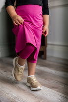 Model wearing Nuggles® Girls' All-Sport Skirt in Hot Pink