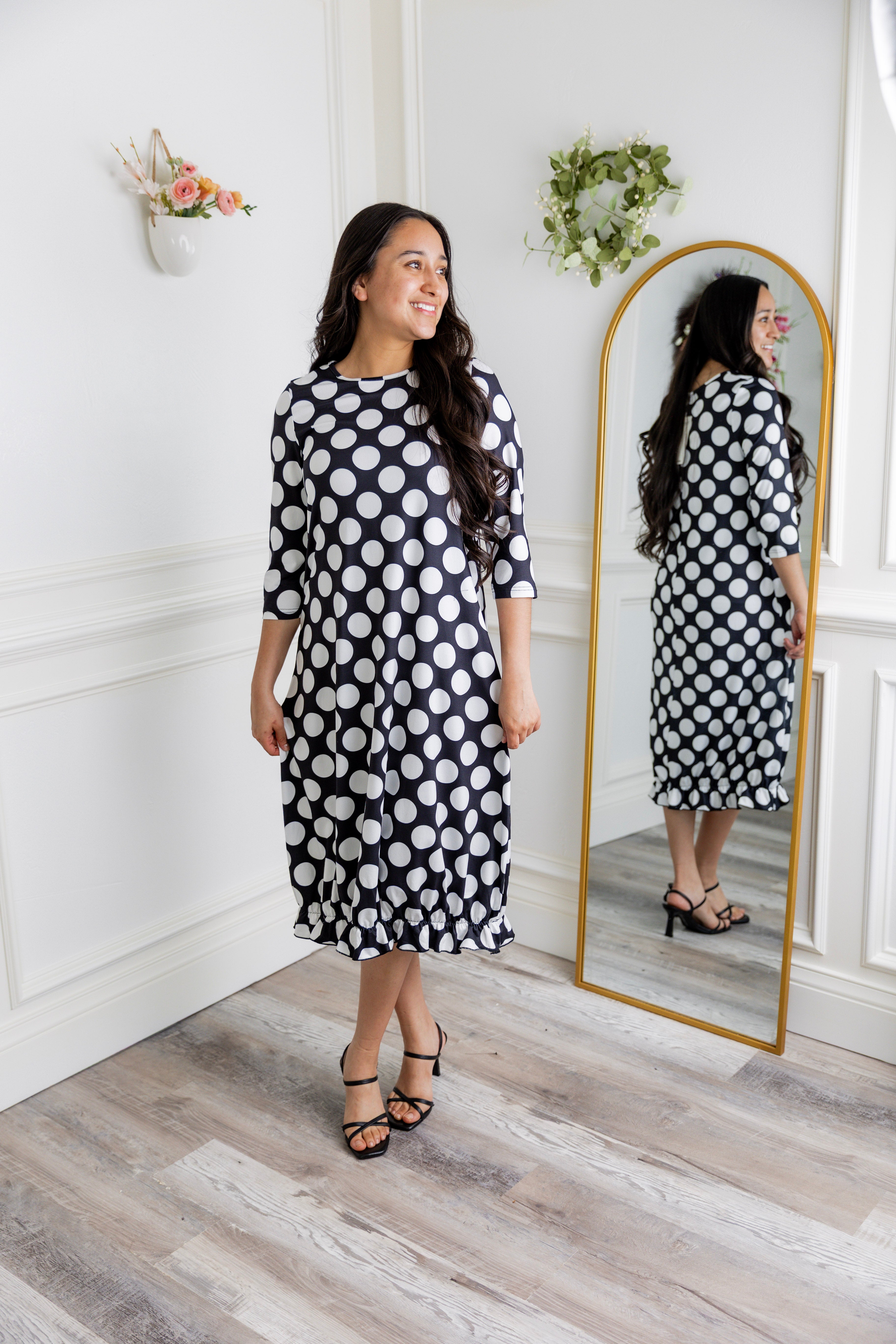 Model wearing our Nuggles® modest Bristol midi dress with 3/4 sleeves and elastic ruffle hem in various prints.