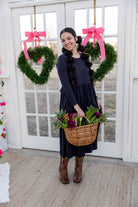 Model wearing the Nuggles® Farah Dress in Navy