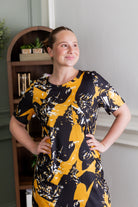 Model wearing Modest Nuggles® Aviva Dress in Golden Drift