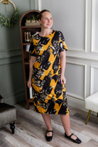 Model wearing Modest Nuggles® Aviva Dress in Golden Drift