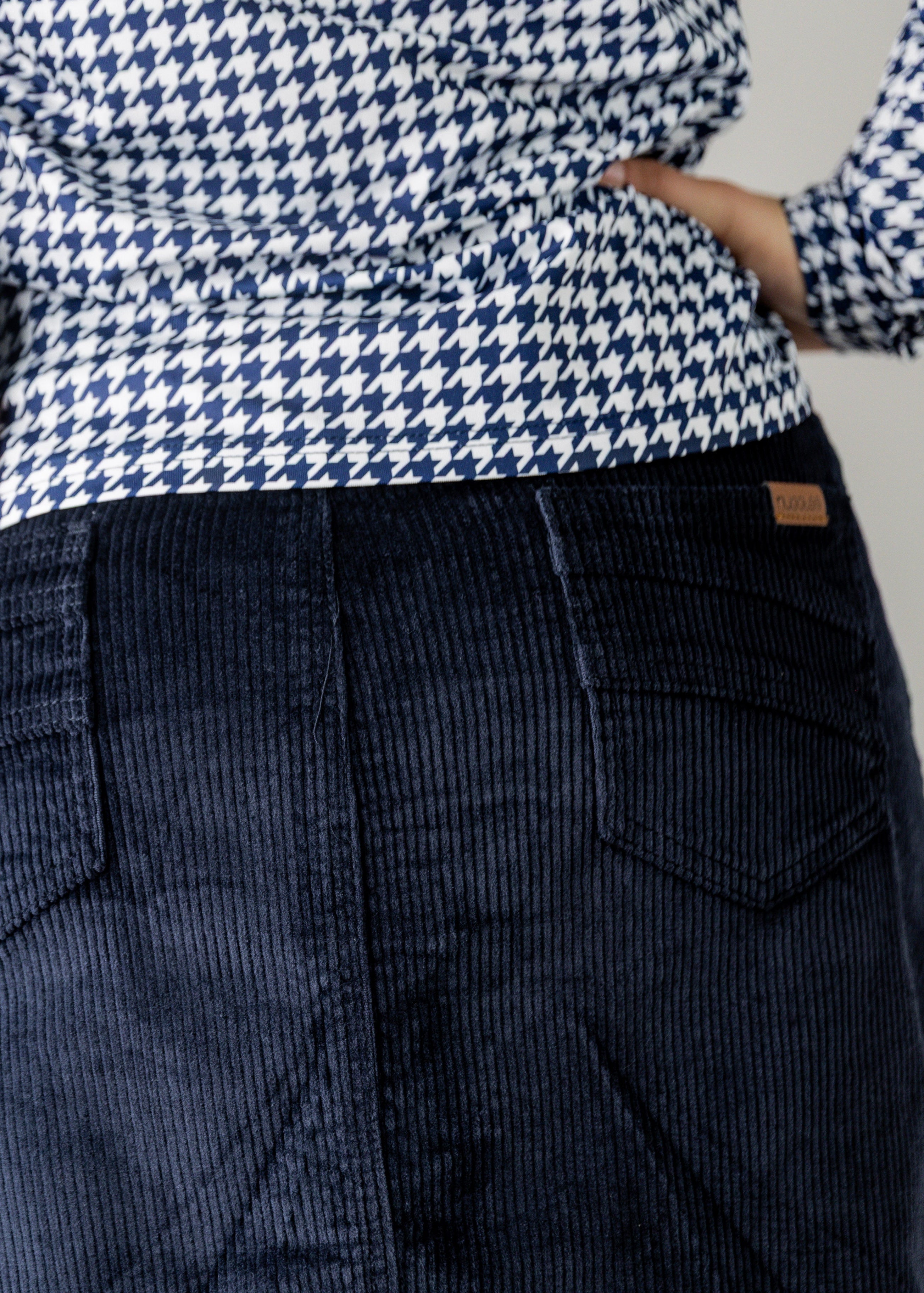 Model wearing Nuggles® 27-inch corduroy skirt