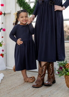 Model wearing the Nuggles® Girls' Farah Dress in Navy