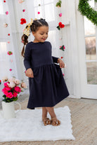 Model wearing the Nuggles® Girls' Farah Dress in Navy
