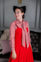 Model wearing Nuggles® Felicity top with large bow tie neckline, modest women's blouse.