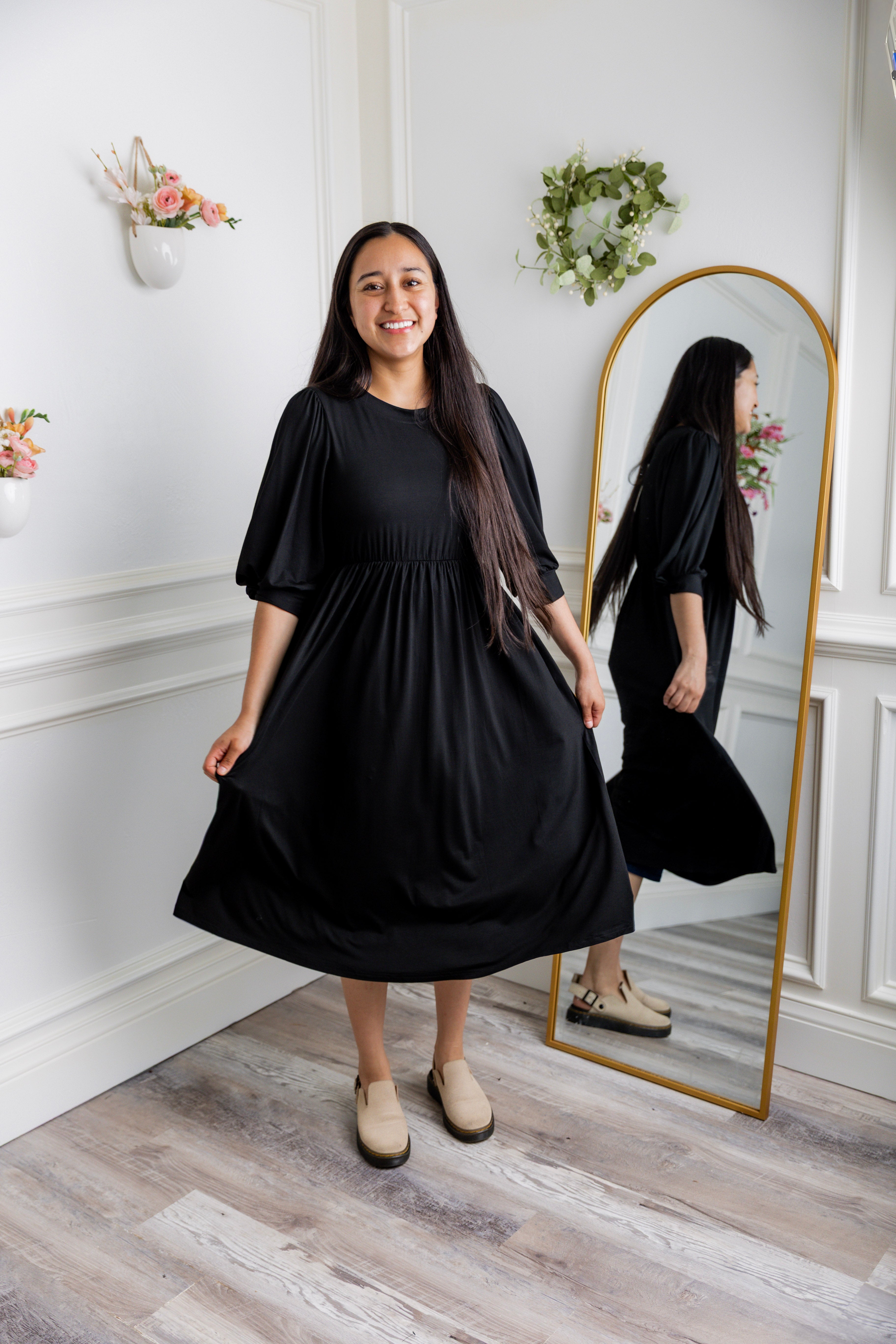 Modest Willow Solid Colors Dress by Nuggles® featuring a gathered waist, balloon sleeves, and side pockets; shown in various solid colors and angles for a stylish, comfortable everyday look.