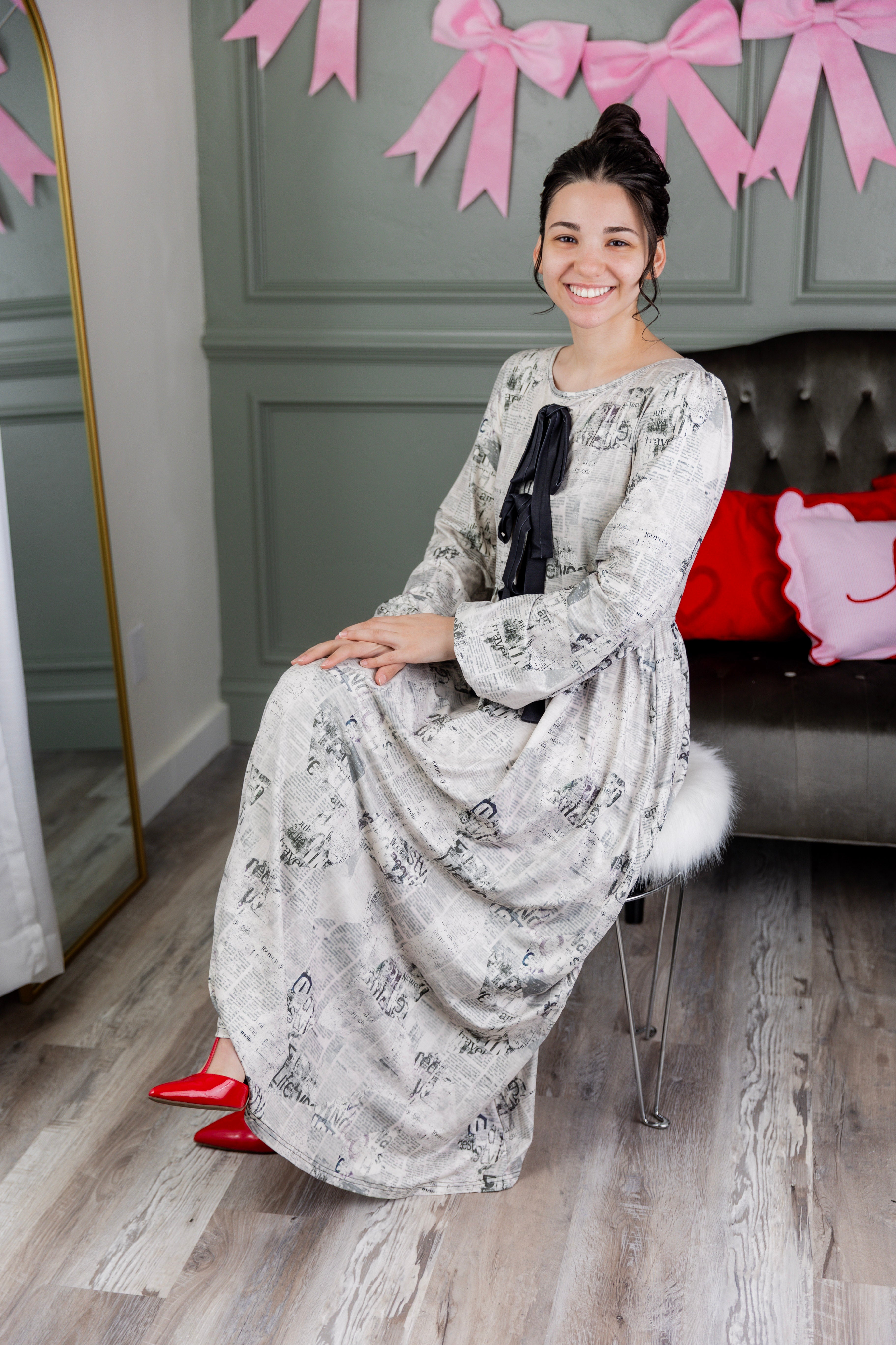 Model wearing the Nuggles® Addison Dress in Whispering Headlines