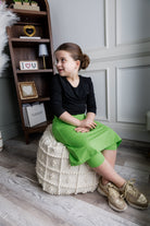 Model wearing Nuggles® Girls' All-Sport Skirt in Green