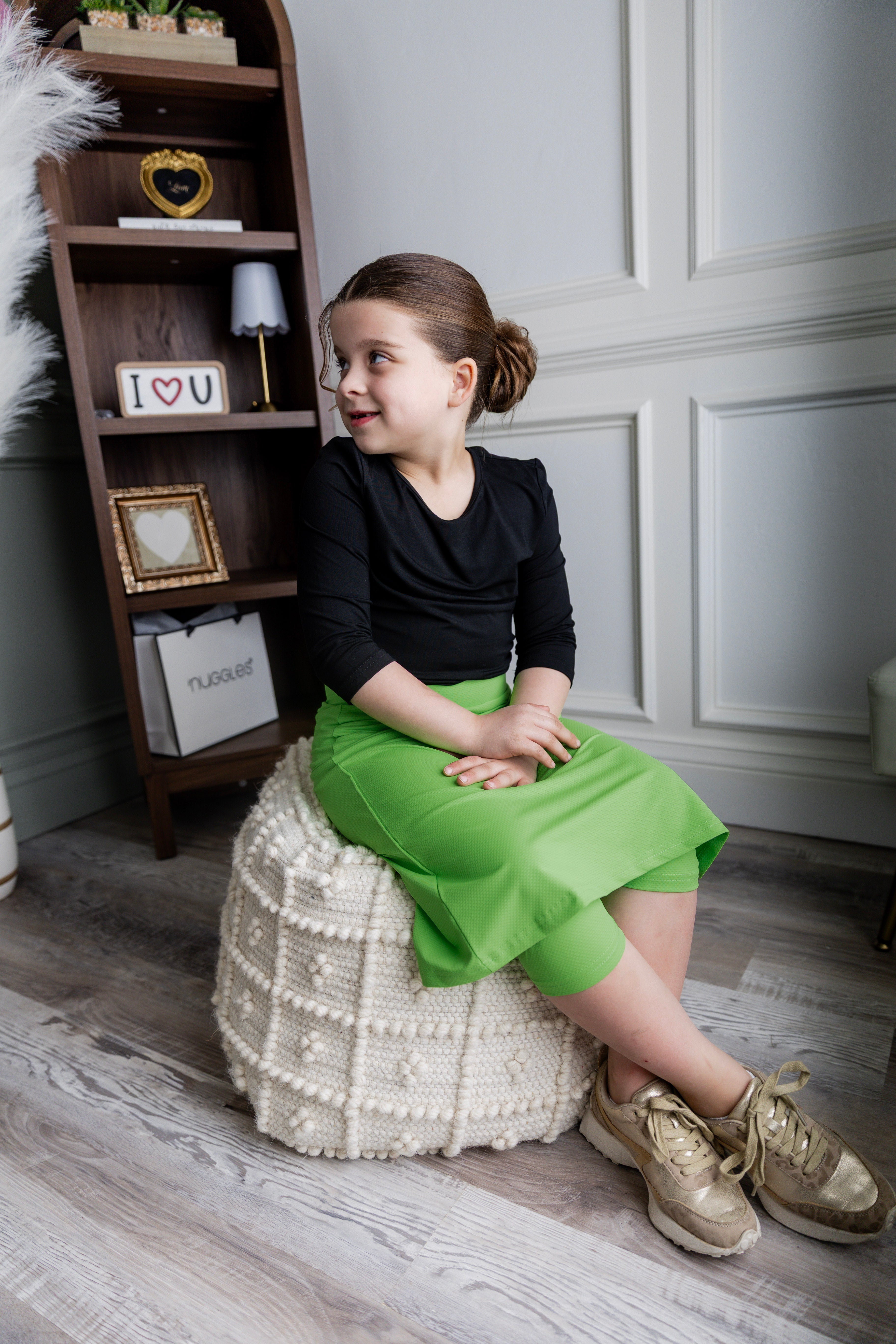 Model wearing Nuggles® Girls' All-Sport Skirt in Green