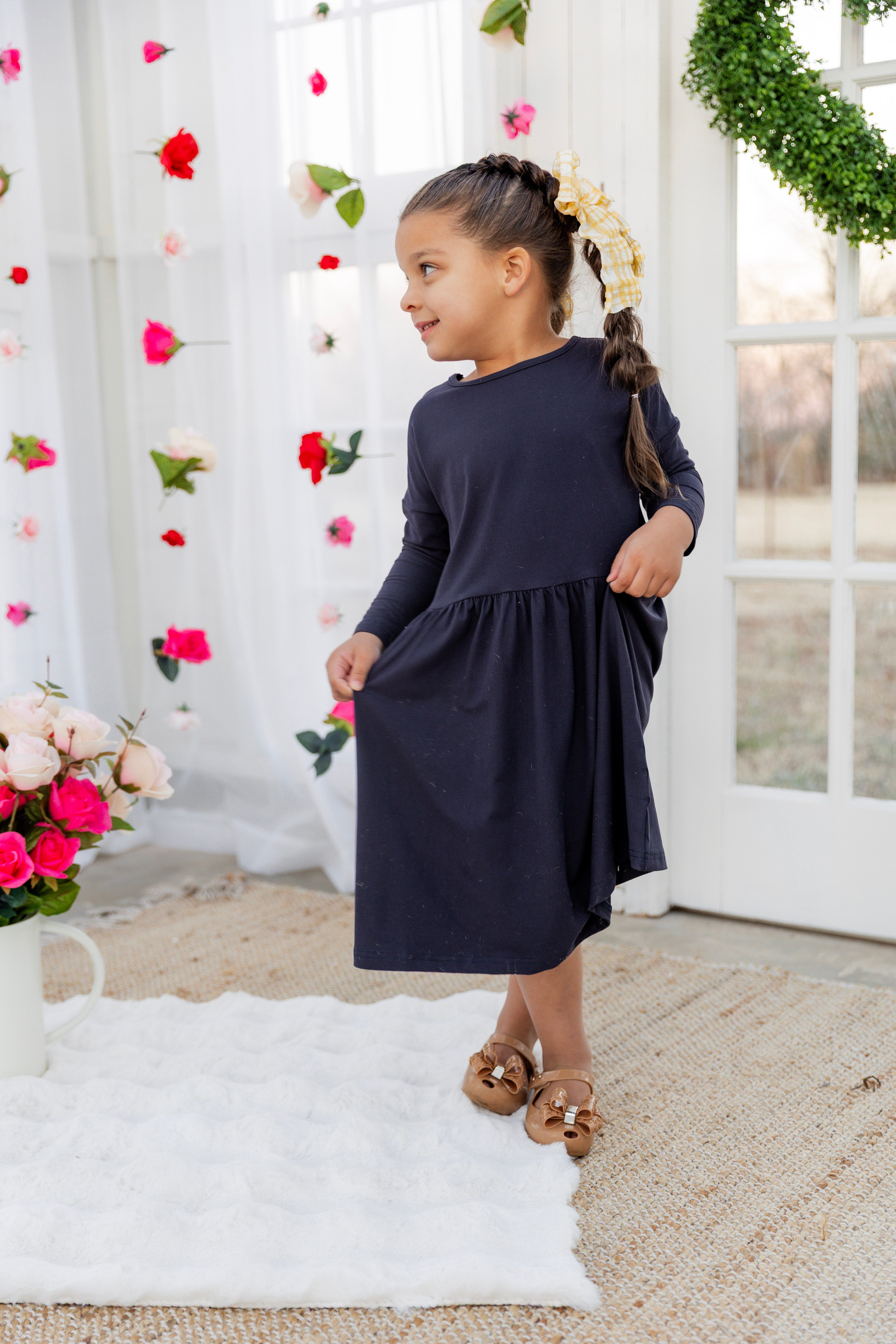 Model wearing the Nuggles® Girls' Farah Dress in Navy