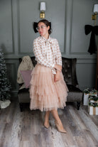 Model wearing Nuggles® Felicity top with large bow tie neckline, modest women's blouse.