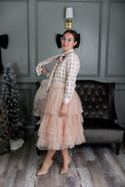 Model wearing Nuggles® Felicity top with large bow tie neckline, modest women's blouse.