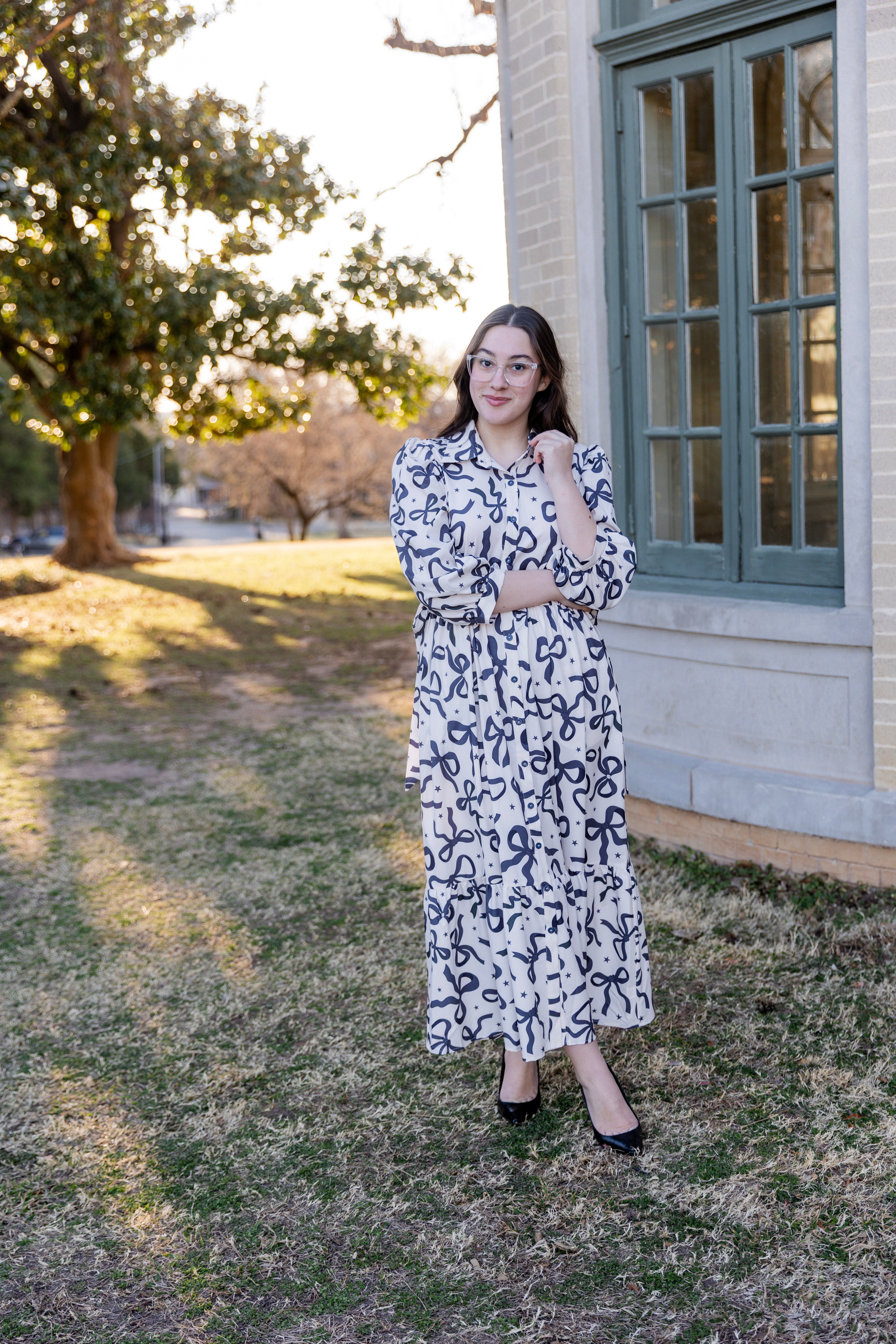 Model wearing the Nuggles® Leila Dress in Bow & Tell