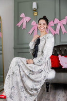 Model wearing the Nuggles® Addison Dress in Whispering Headlines