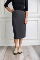 Model wearing a 27-inch classic lightweight midi skirt with an elastic waistband, styled modestly for everyday or church wear.