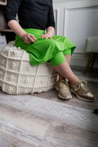 Model wearing Nuggles® Girls' All-Sport Skirt in Green