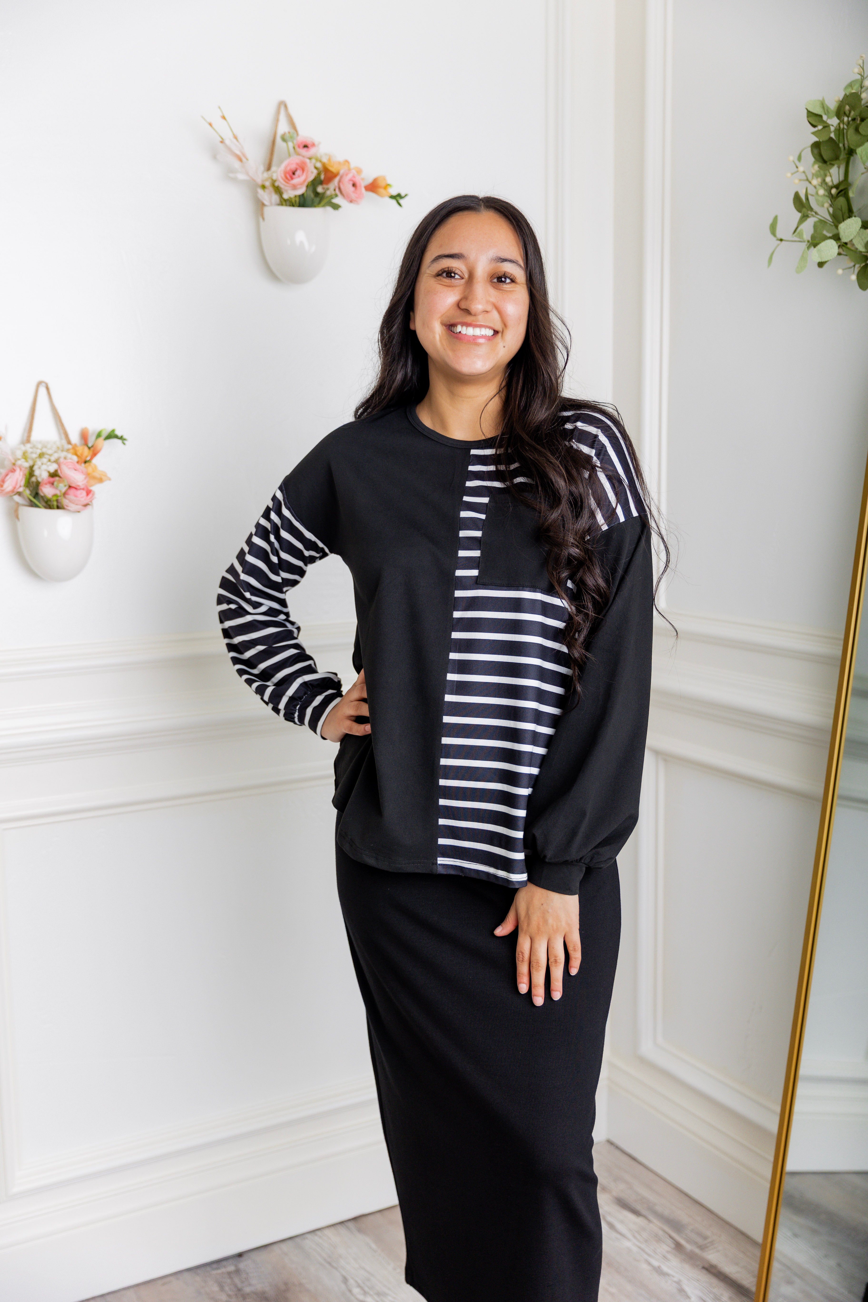 Model wearing the Nuggles® Harlow Top with red and navy color block design.