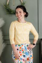 Model wearing Nuggles® 27" Sport Skirt in  Party Sprinkles and 3/4 Essential Tee in Lemon Drop Stripe