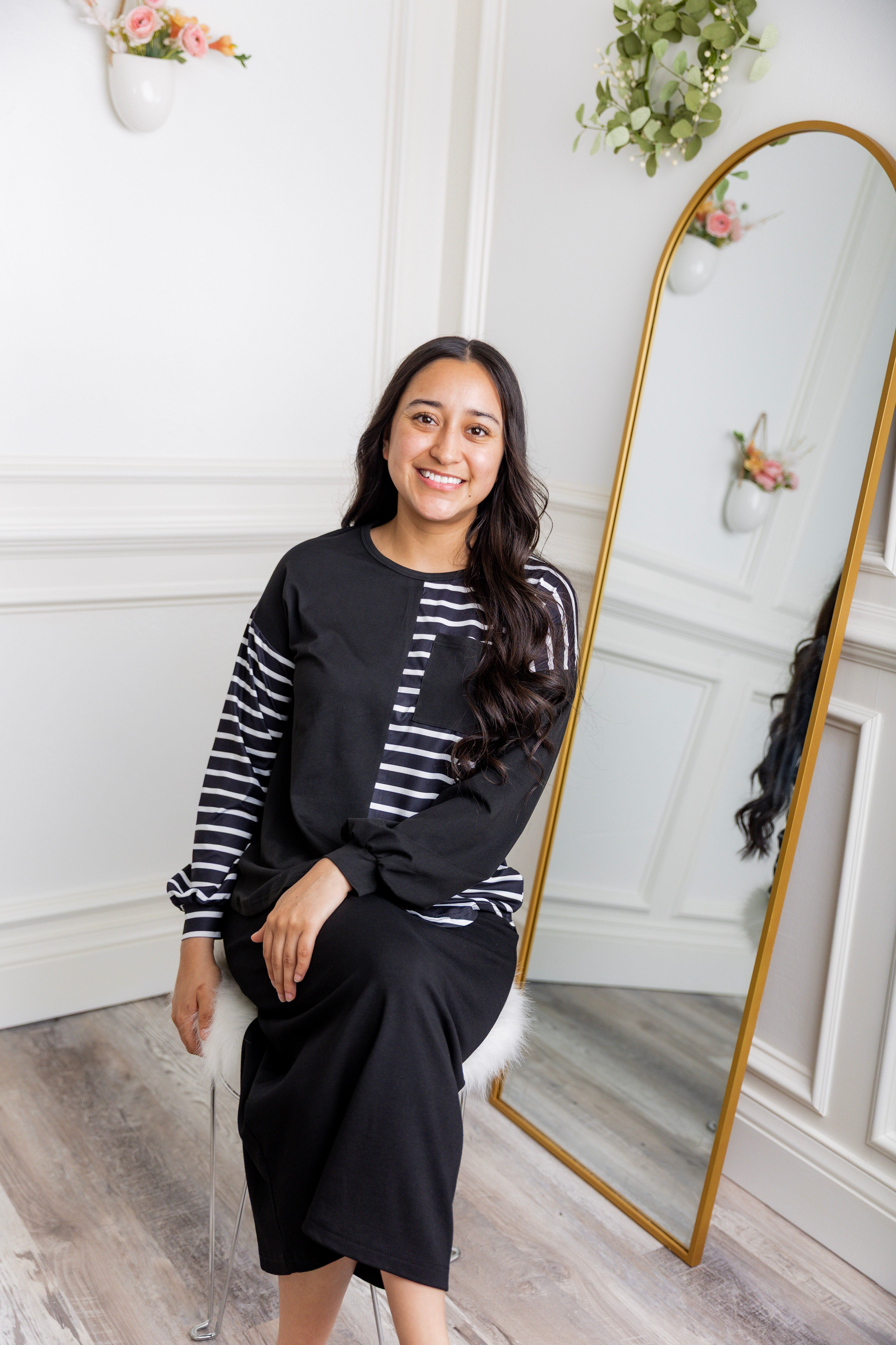 Model wearing the Nuggles® Harlow Top with red and navy color block design.