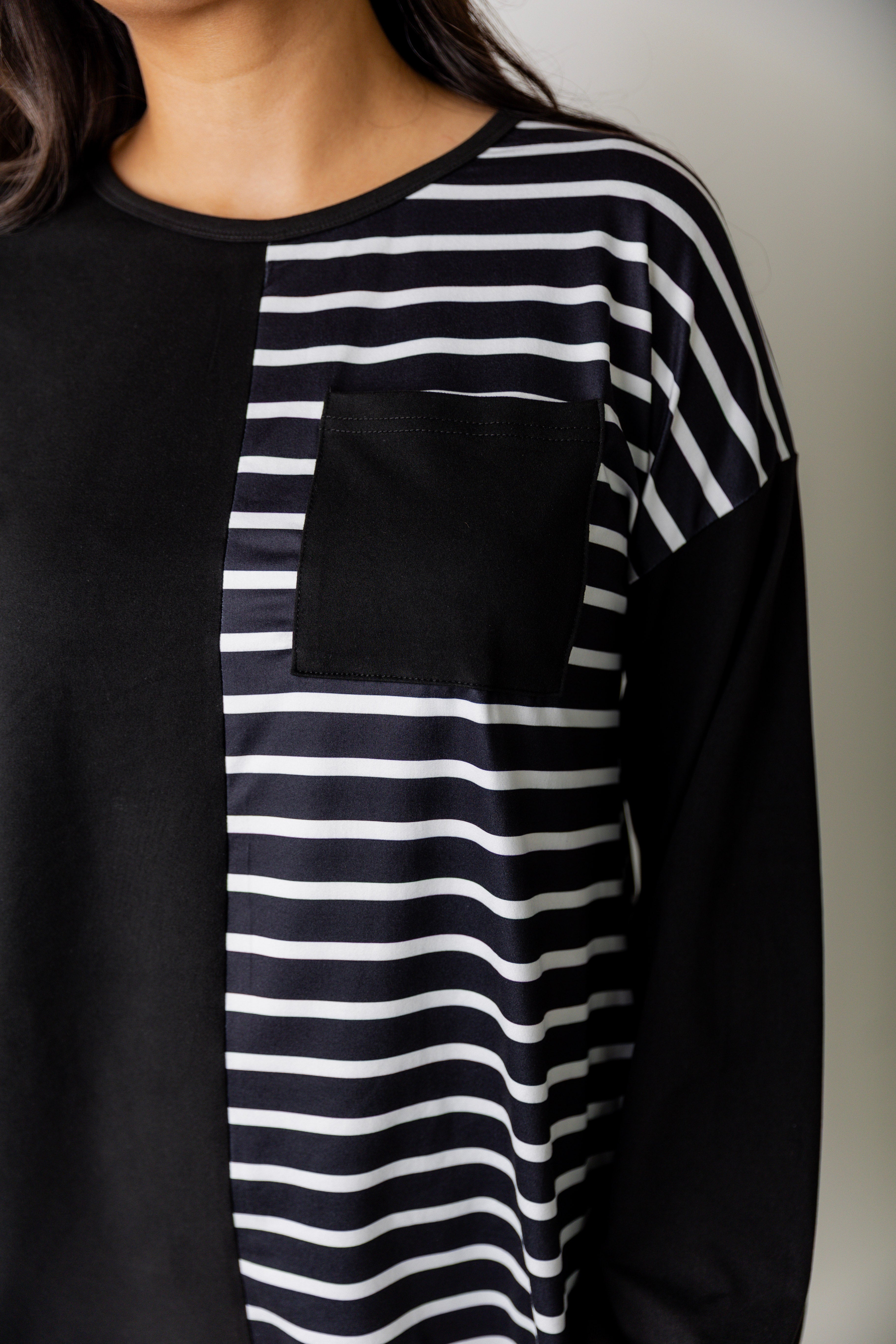 Model wearing the Nuggles® Harlow Top with red and navy color block design.