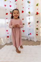 Model wearing the Nuggles® Girls' Farah Dress in Baby Pink
