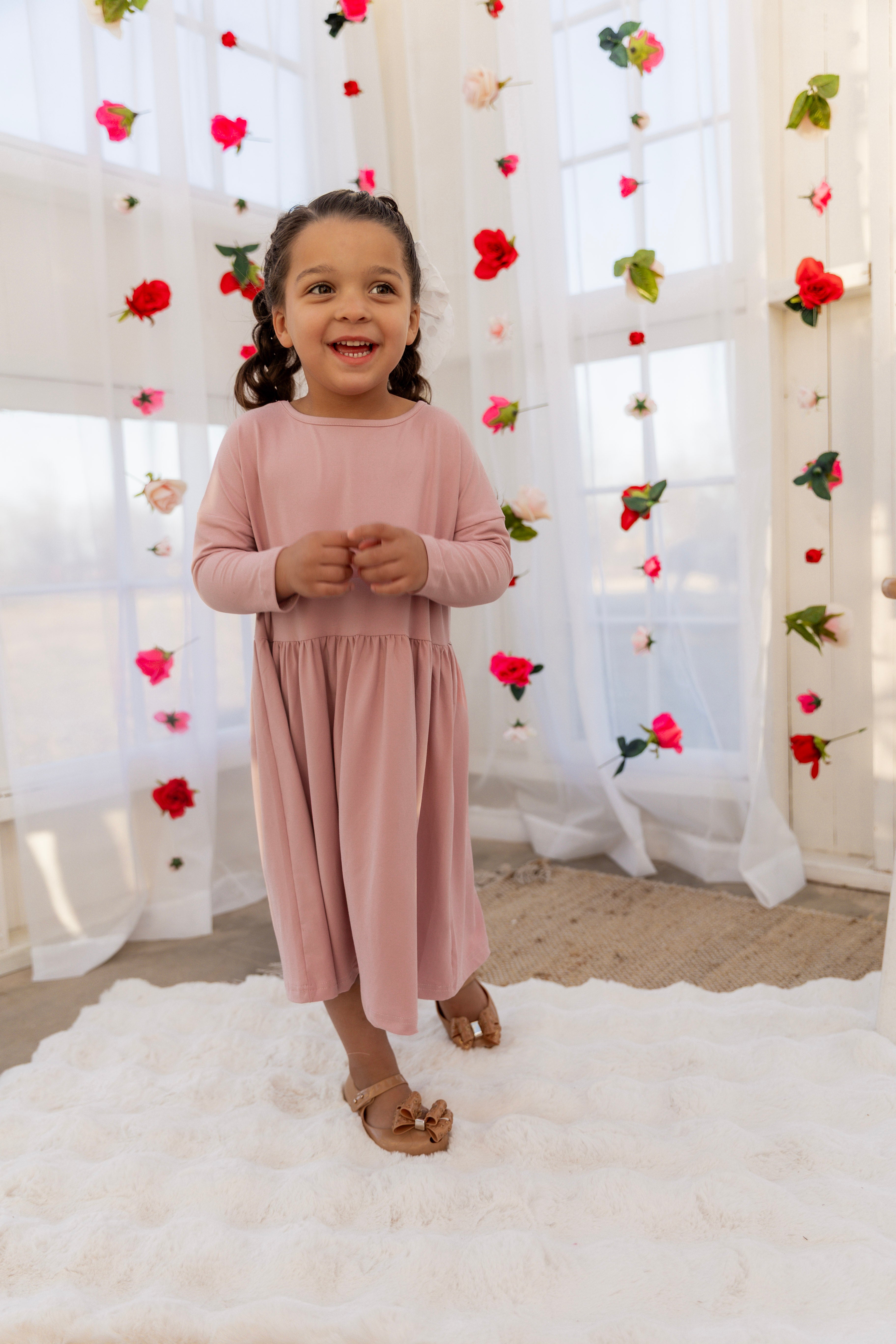 Model wearing the Nuggles® Girls' Farah Dress in Baby Pink