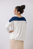 Model wearing the Nuggles® Keegan Top in Dewdrop Ivory floral print modest boutique top