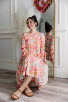 Model wearing the Nuggles® Hazel Dress in Confetti Garden Bloom floral print modest boutique dress