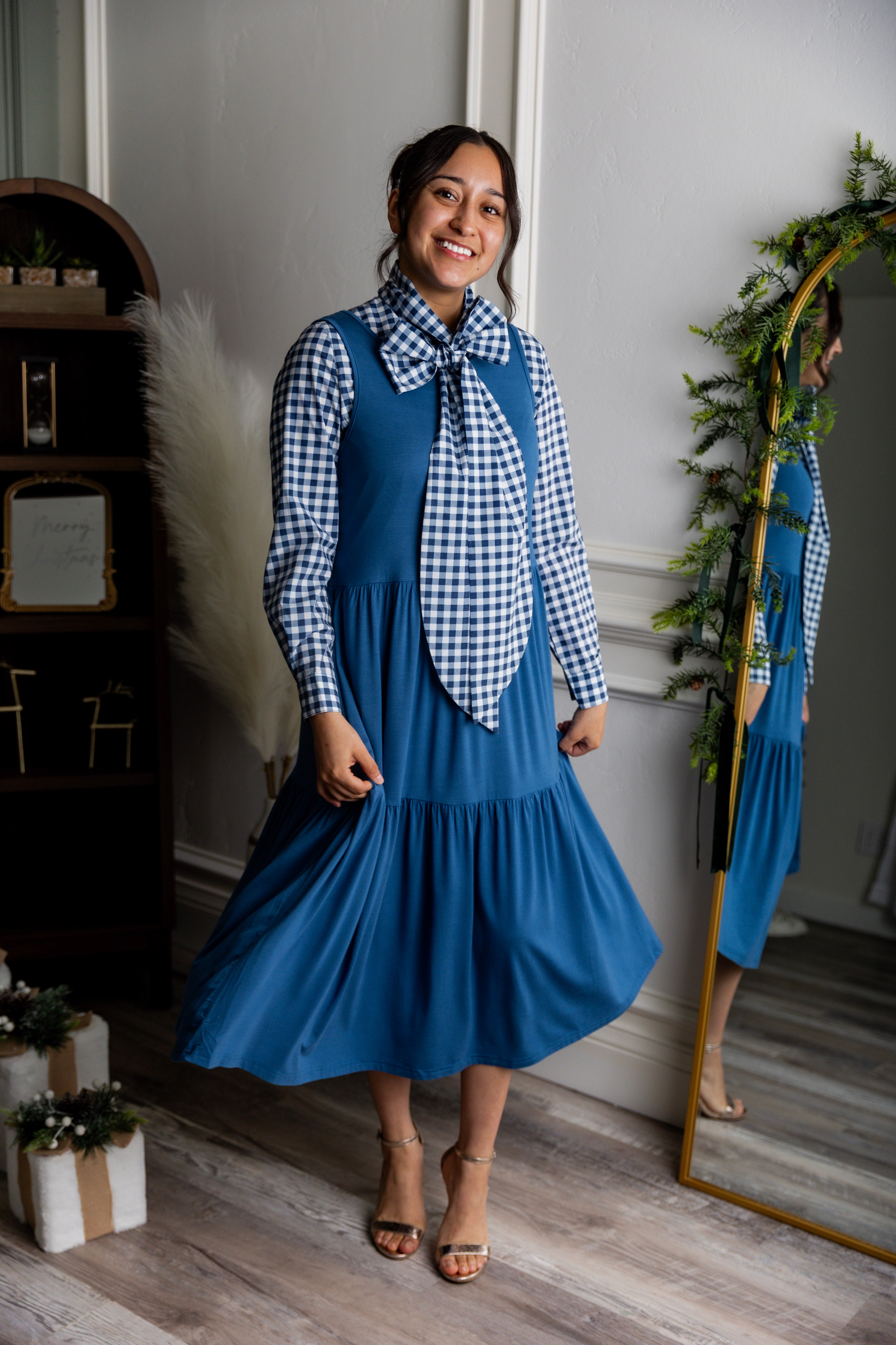 Model wearing Nuggles® Felicity top with large bow tie neckline, modest women's blouse.