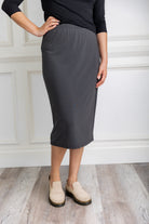 Model wearing a 27-inch classic lightweight midi skirt with an elastic waistband, styled modestly for everyday or church wear.