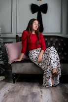 Model wearing the Nuggles® Sage Skirt in white with black bow print, featuring a gathered tiered hem and adjustable drawstring waist.