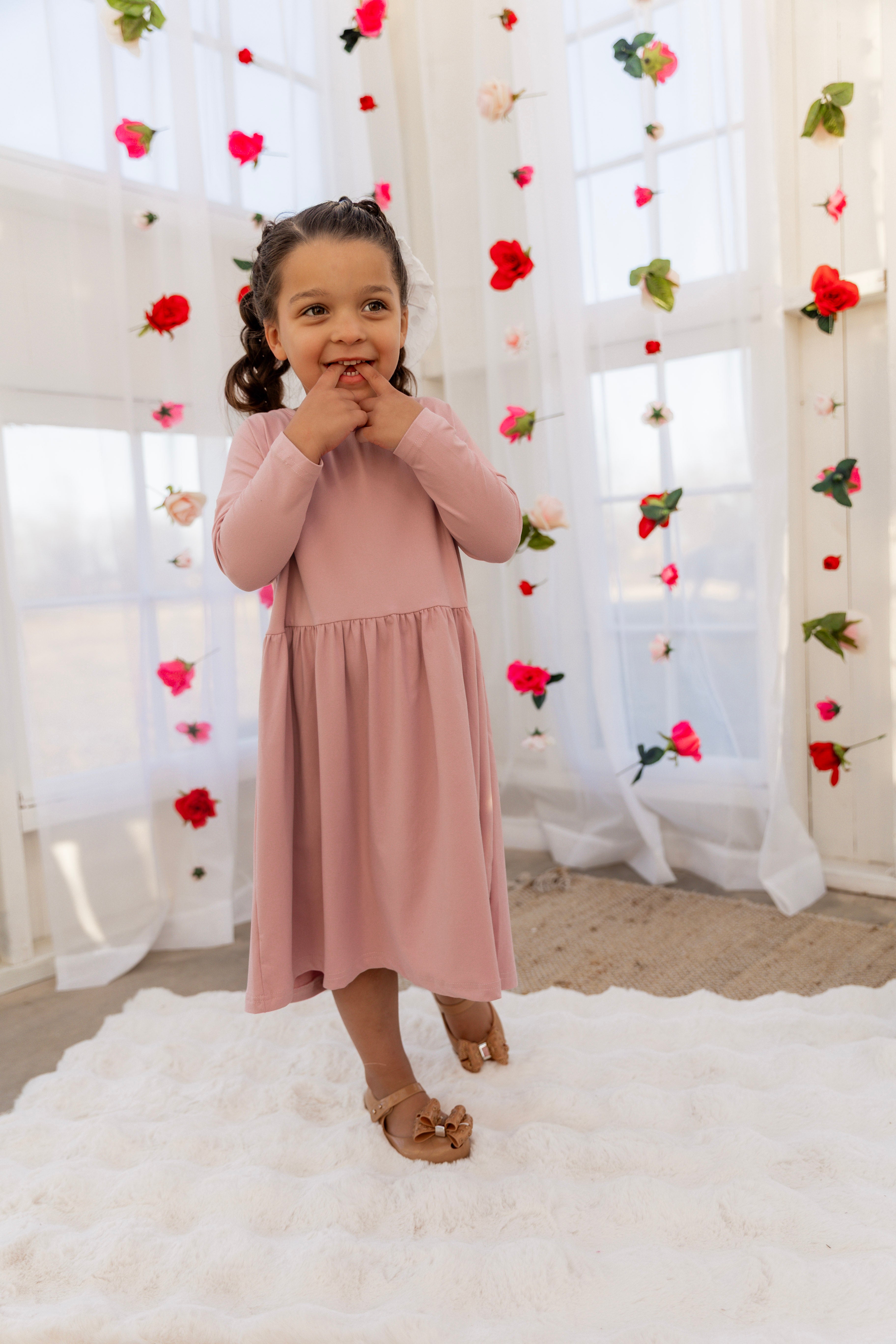 Model wearing the Nuggles® Girls' Farah Dress in Baby Pink