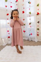 Model wearing the Nuggles® Girls' Farah Dress in Baby Pink