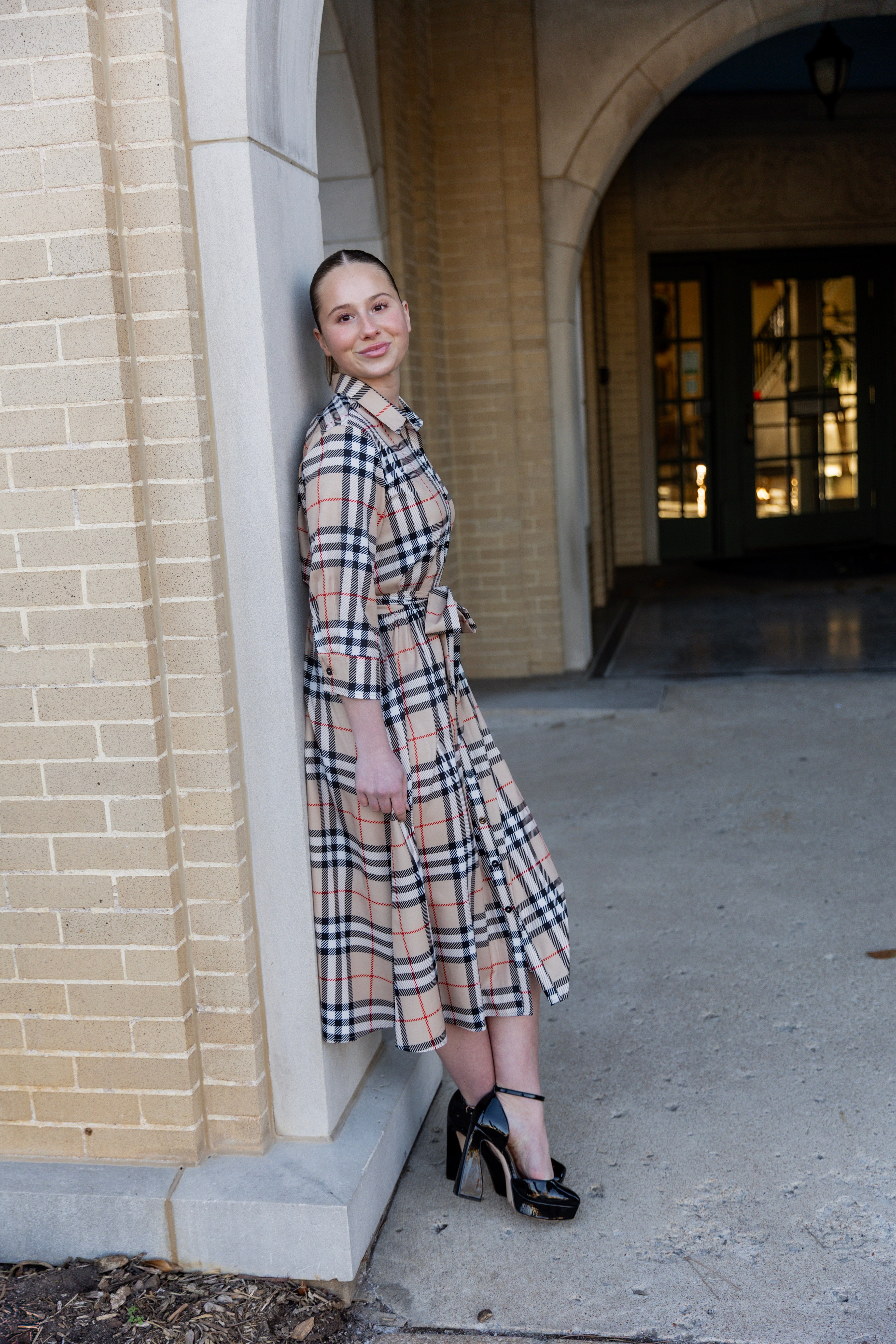 Model wearing the Nuggles® Rachel Dress in Sand Plaid