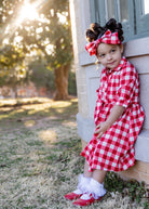 Model wearing the Nuggles® Girls' Rachel Dress and matching Headband in Cherry Jam