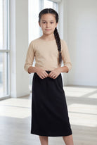 Model wearing the Nuggles® Girls' Classic Midi Skirt in Black