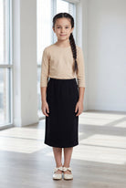 Model wearing the Nuggles® Girls' Classic Midi Skirt in Black