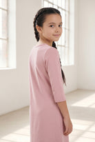 Model wearing Nuggles® Girls Layering Dress in Baby Pink