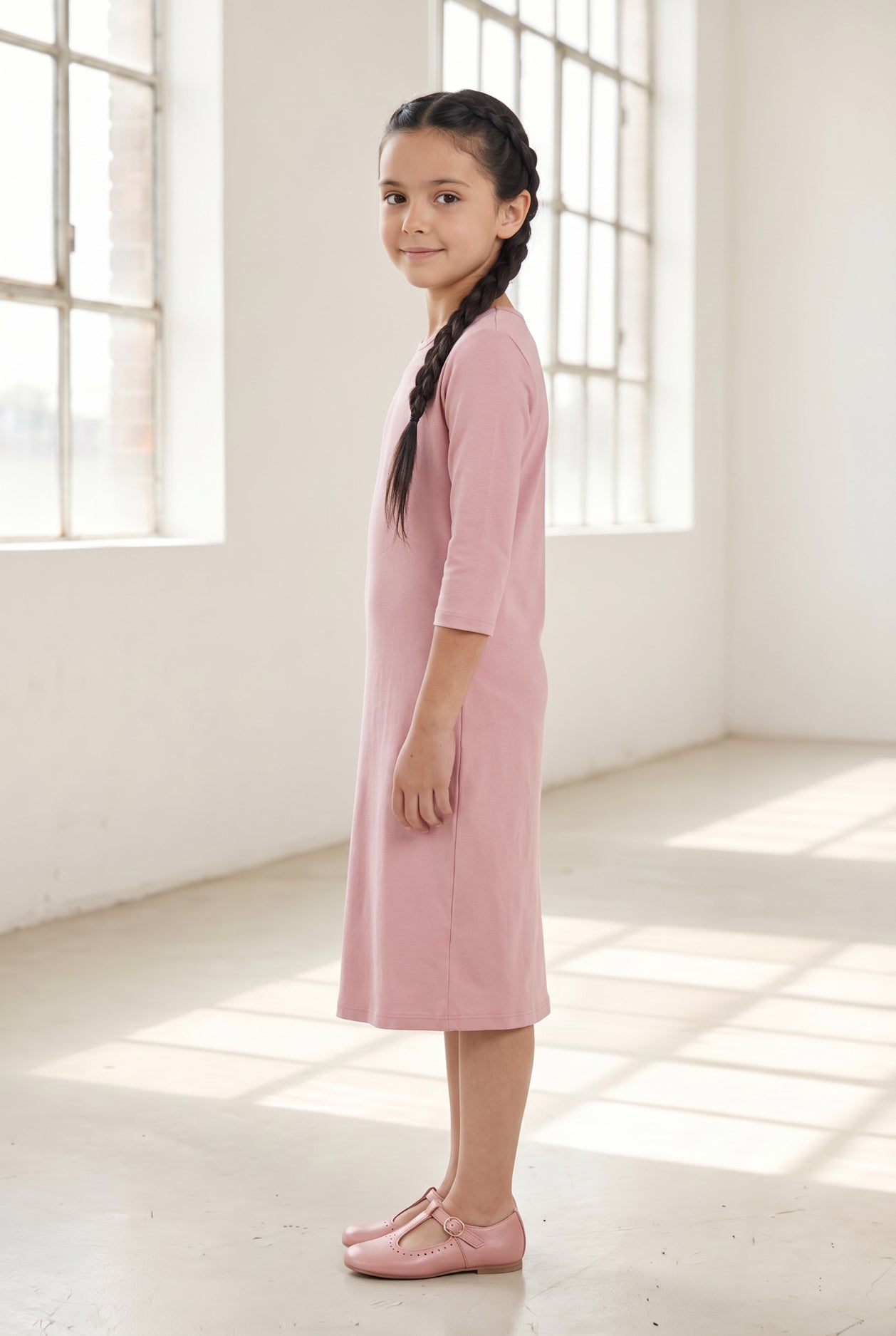 Model wearing Nuggles® Girls Layering Dress in Baby Pink