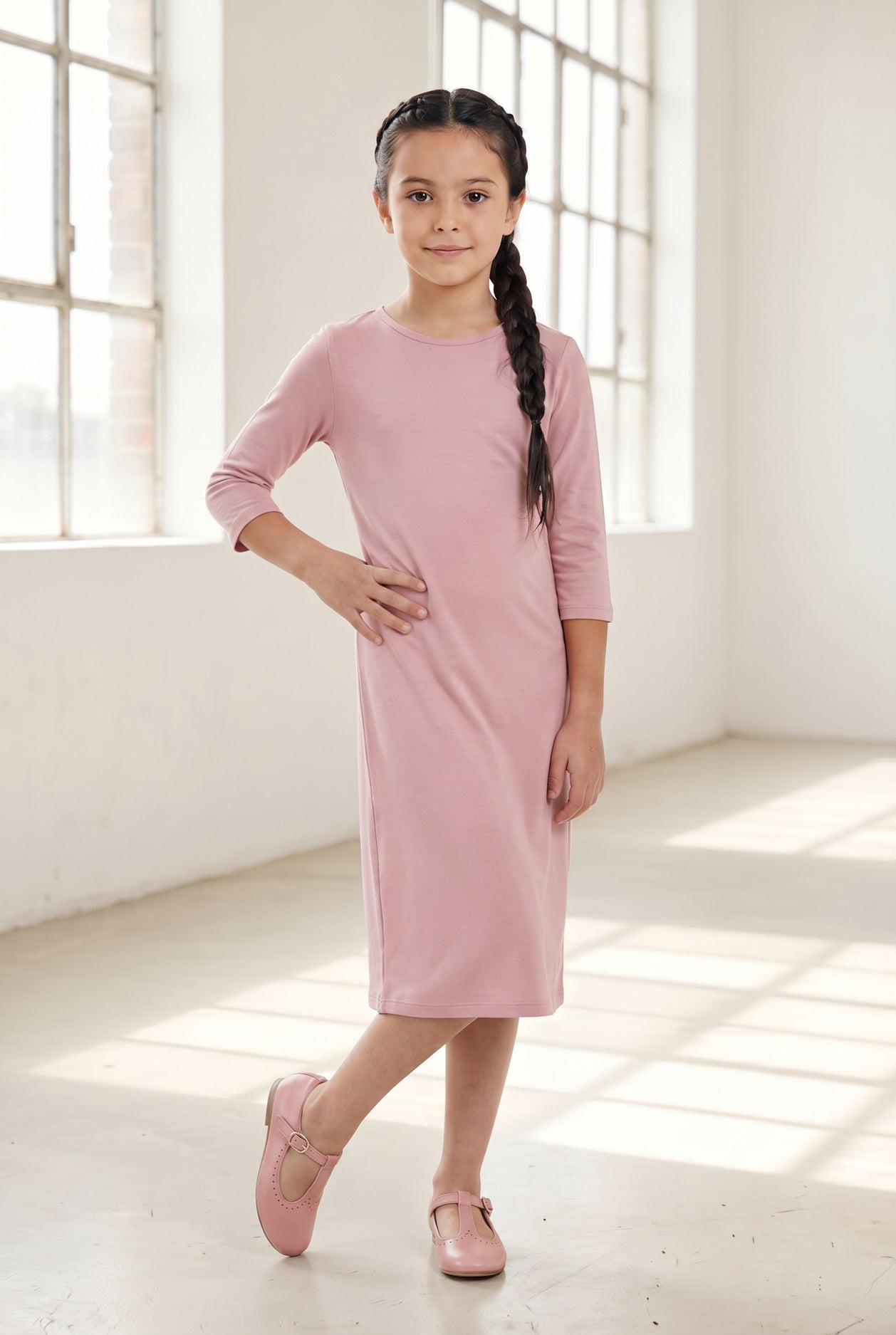 Model wearing Nuggles® Girls Layering Dress in Baby Pink