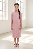 Model wearing Nuggles® Girls Layering Dress in Baby Pink