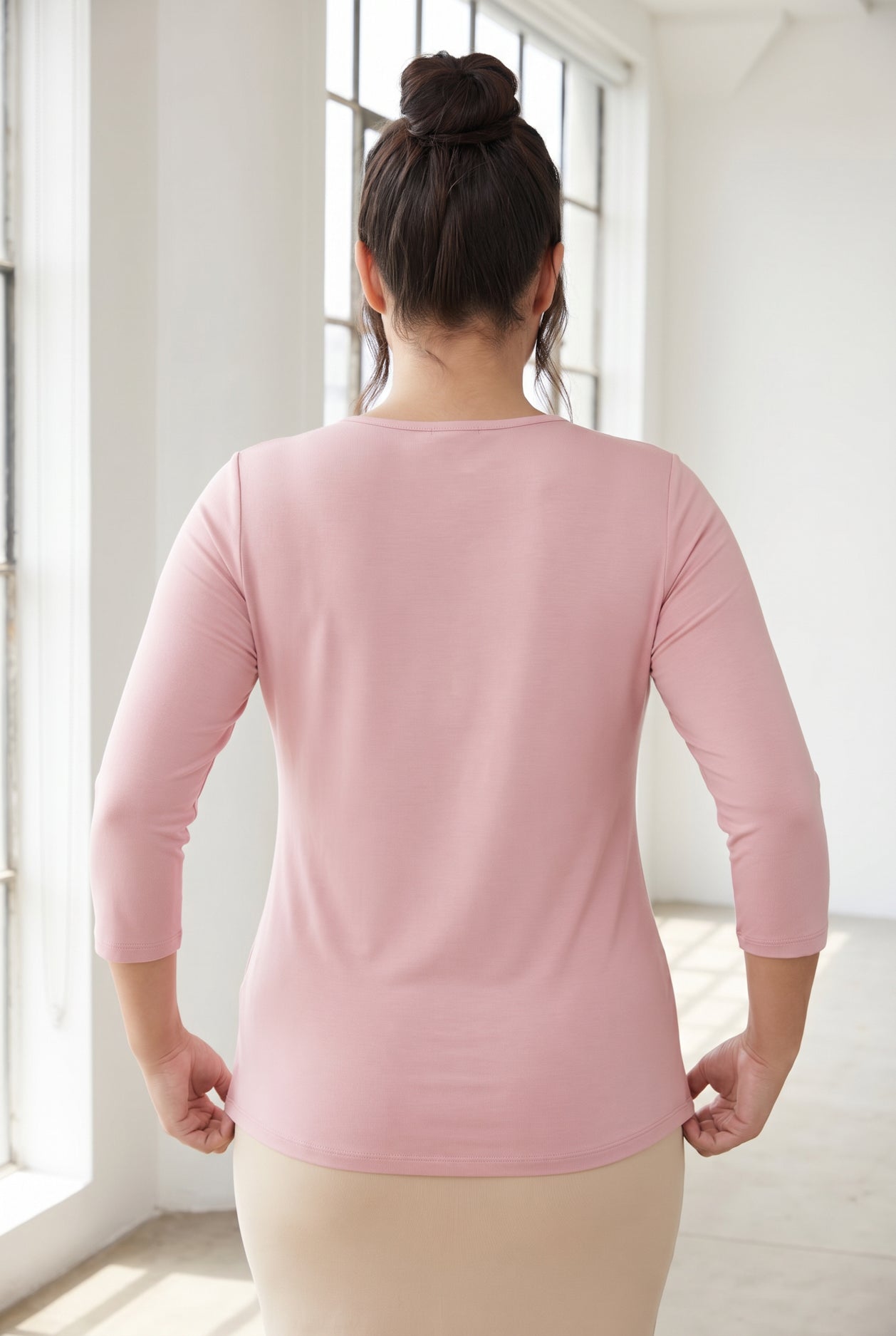 Model wearing Nuggles® 3/4 Essential Tee in Baby Pink